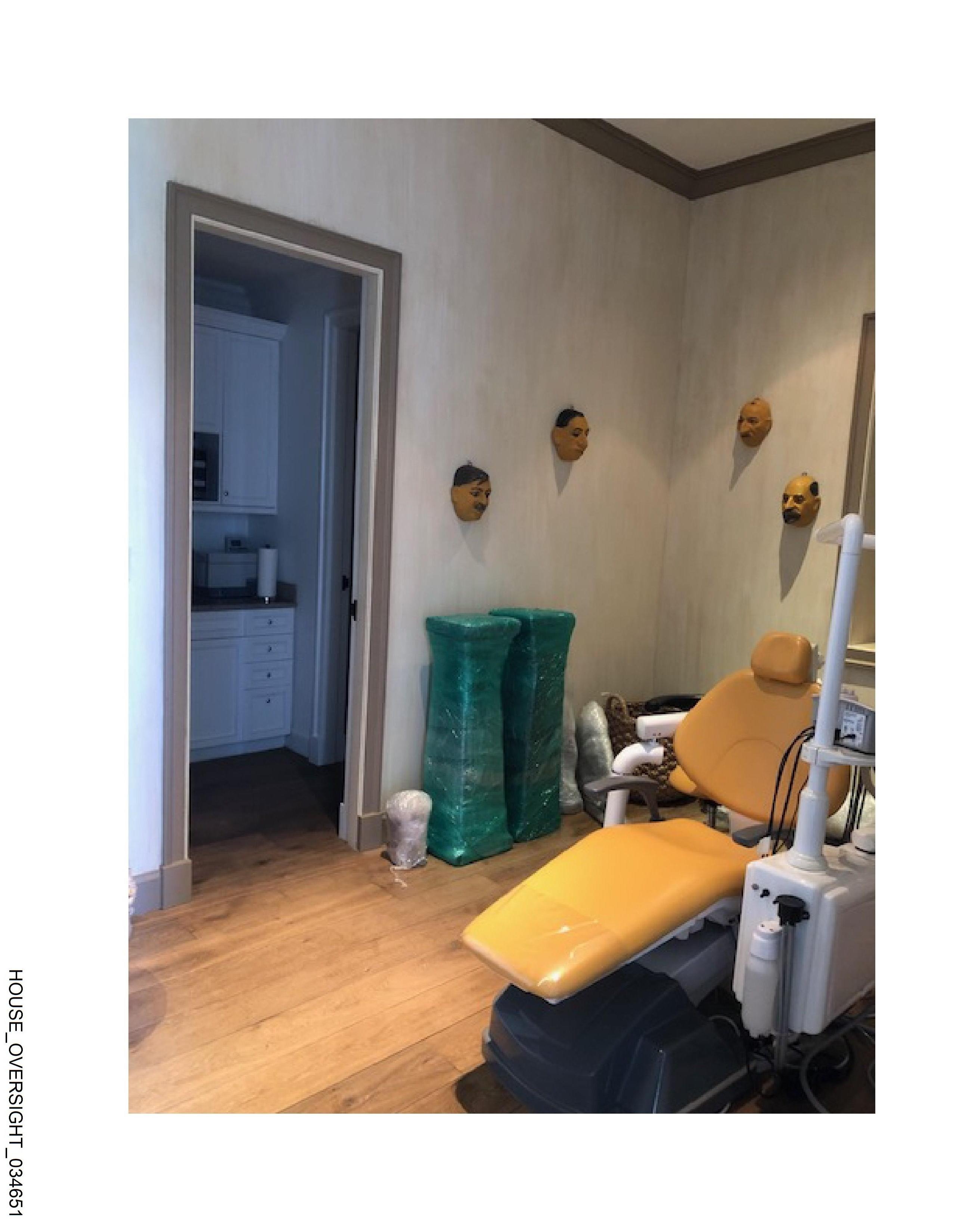 Dental chair with face masks on wall